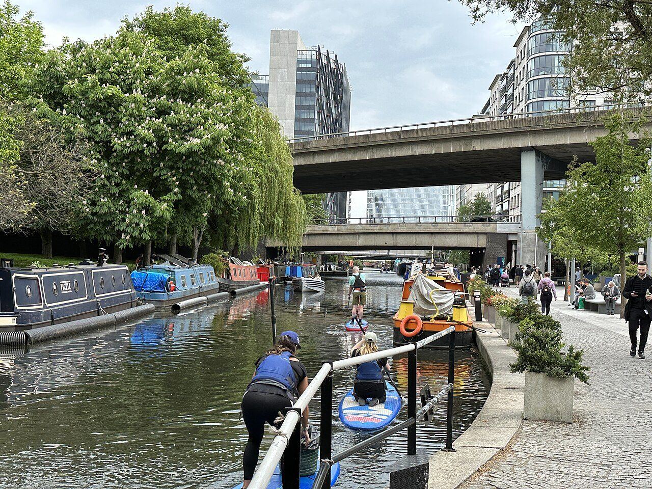 Paddle boarders and narrowboats on the Paddington branch of the Grand Union Canal